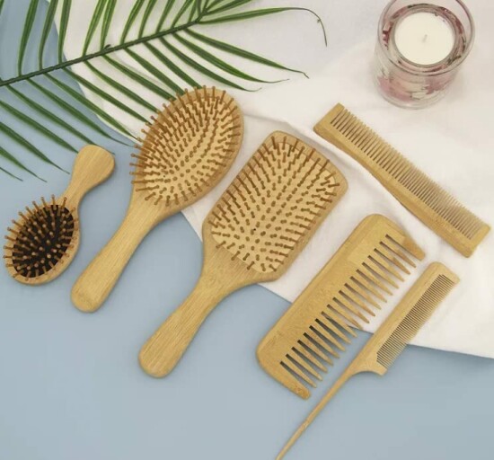 A close-up image of the 6 in 1 Wooden Natural Bamboo Detangling Hair Brush and Comb Set by BeaverStrong, showcasing its natural wooden and bamboo materials.