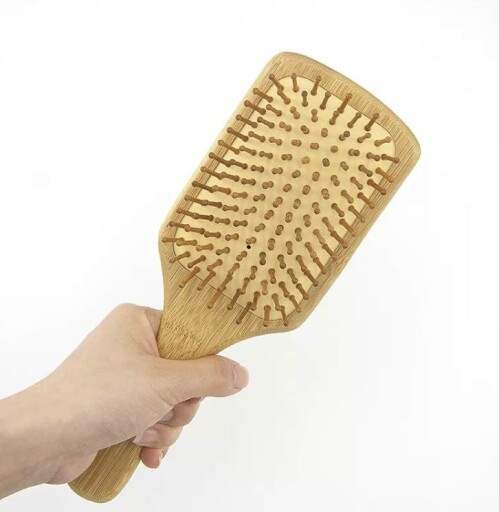 A close-up image of the handles of the 6 in 1 Wooden Natural Bamboo Detangling Hair Brush and Comb Set by BeaverStrong, showcasing the natural wooden material.