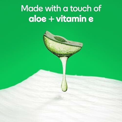 Aloe and vitamin E skincare product with green background.