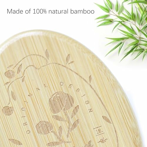 Bamboo board with engraved design and green leaves.