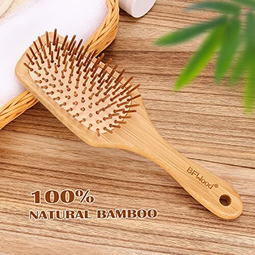 Bamboo hairbrush with wooden bristles on a wooden surface.