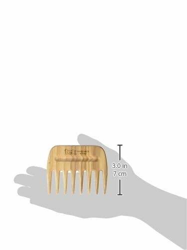 Bamboo hair comb resting on a hand for size reference.