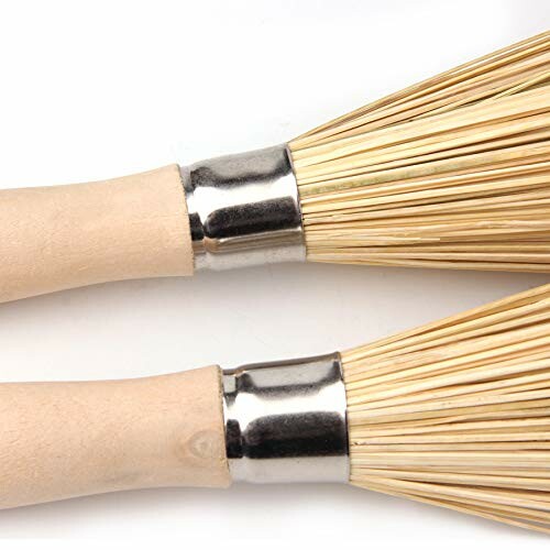 Two bamboo tea whisks with wooden handles