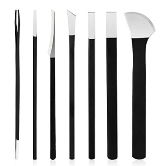 Set of black metal sculpting tools with various tips.