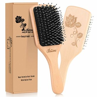 Wooden boar bristle hair brush set with floral engraving.