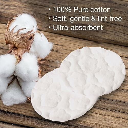 Cotton pads on a wooden surface with cotton plant.