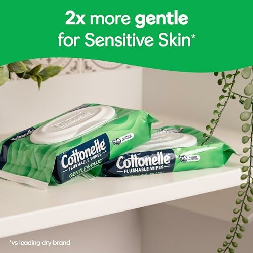 Cottonelle flushable wipes on a shelf with greenery.