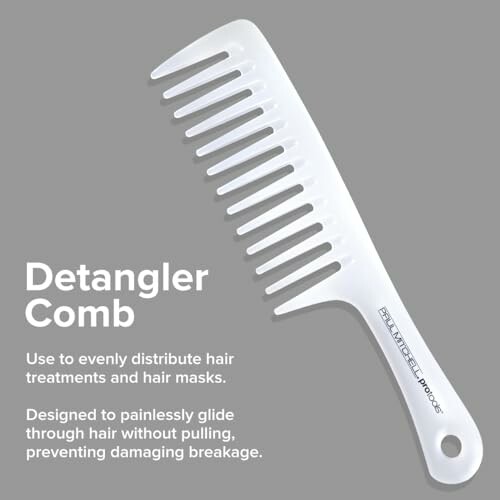 White detangler comb on gray background with product description.