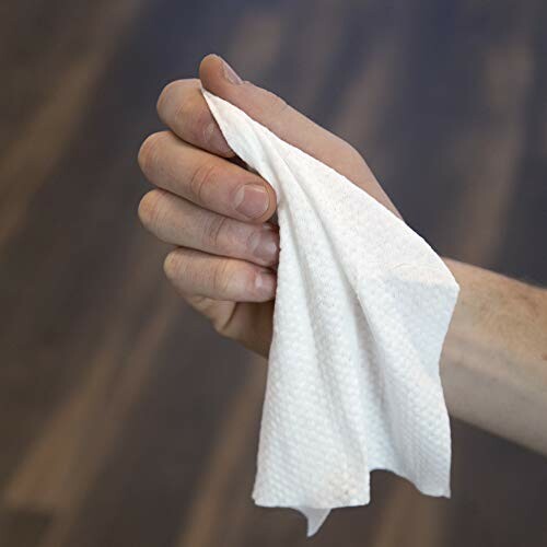 Hand holding a white towel