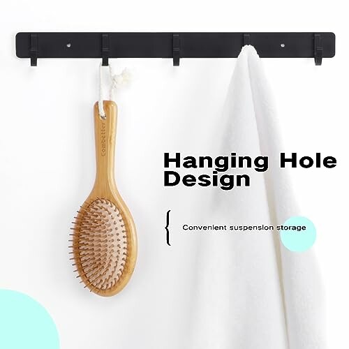 Wooden brush and white towel hanging on hooks.