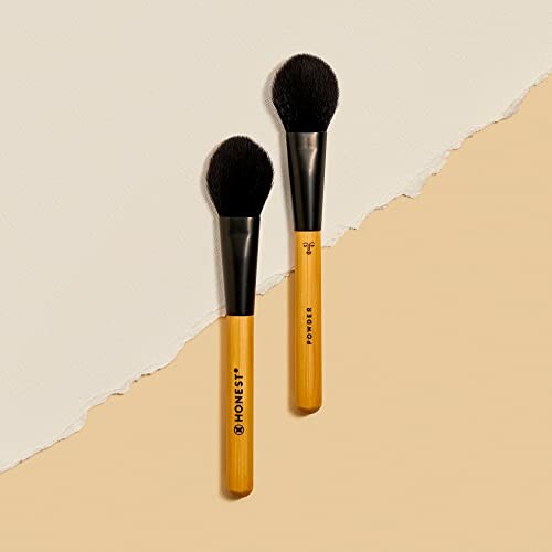 Two Honest Beauty makeup brushes on a textured background