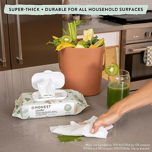 Cleaning wipes used on countertop with compost bin and juice.