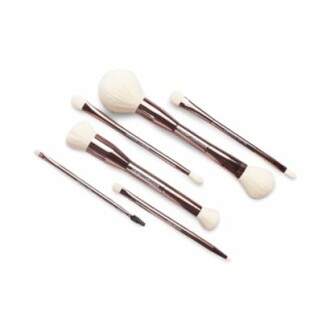 Set of various makeup brushes with white bristles and brown handles.