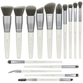 Set of makeup brushes with white handles and various brush heads.