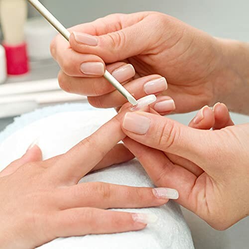 Close-up of a manicure process with nail file.