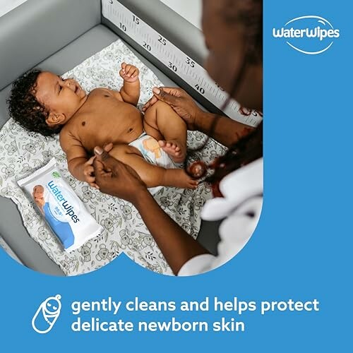 Newborn baby being gently cleaned with WaterWipes.