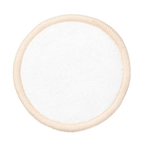 Round reusable cotton face pad with beige trim.