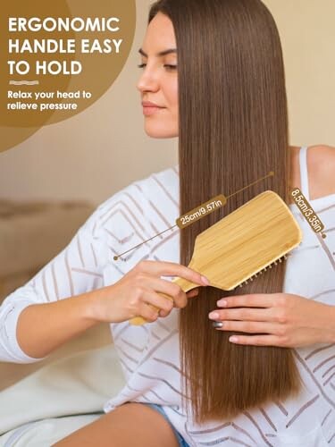 Woman brushing long hair with ergonomic wooden brush