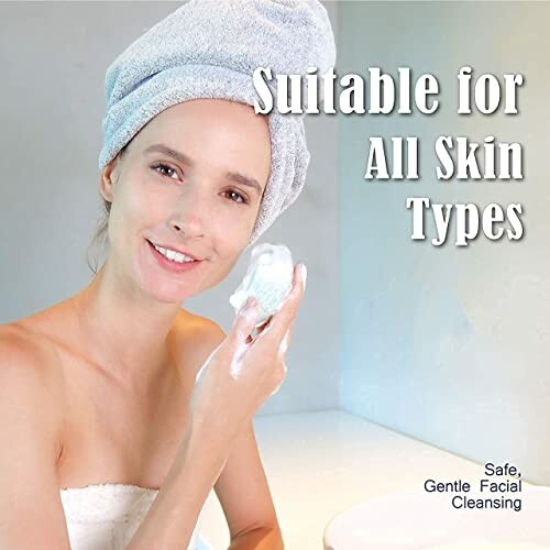 Woman with towel on head using facial cleanser, suitable for all skin types.