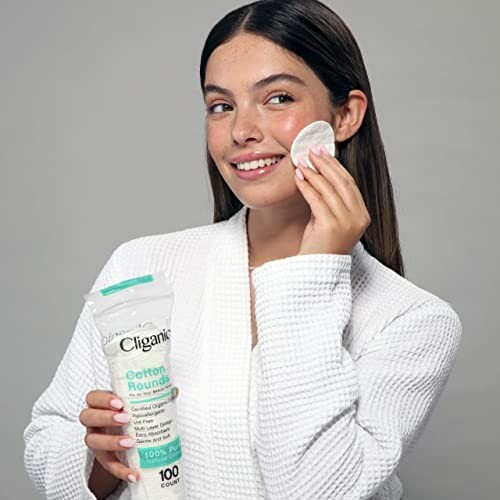 Woman using cotton rounds on her face