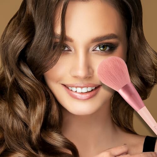 Woman smiling with a makeup brush on her cheek.