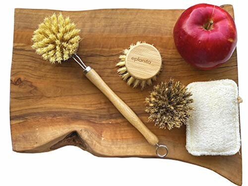 Wooden brushes, apple, and loofah on a wooden board.