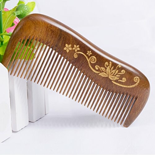 Wooden comb with floral engraving