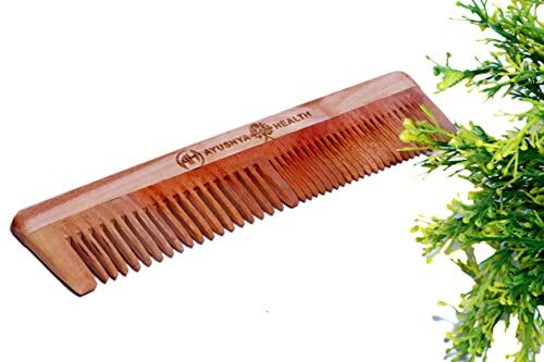 Wooden comb with greenery on side