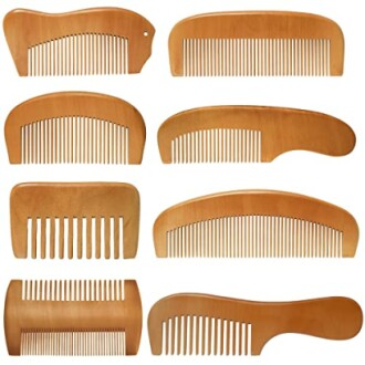 Set of eight wooden combs with different shapes and sizes.