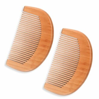 Two wooden combs on a white background