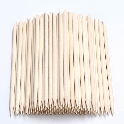 A pile of wooden cuticle sticks arranged neatly.