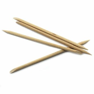 Four wooden cuticle sticks on a white background