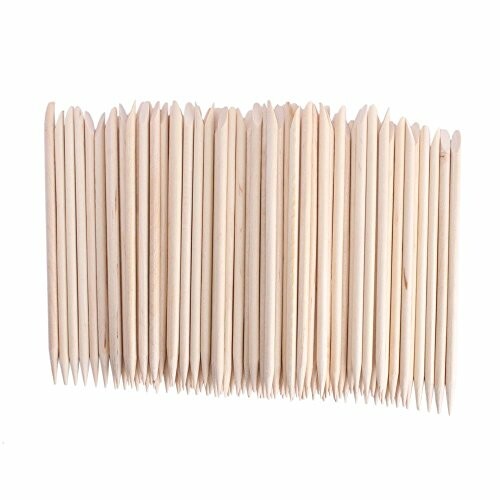 A collection of wooden cuticle sticks arranged in a row.