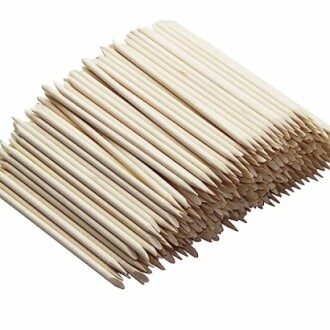 Pile of wooden cuticle sticks stacked neatly