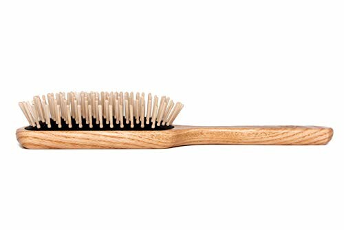 Wooden hairbrush with bristles on white background. 