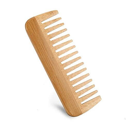 Wooden comb with wide teeth on a beige background