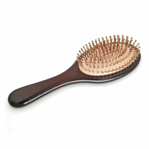 Wooden hairbrush with rounded bristles.