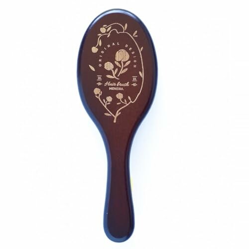 Wooden hairbrush with floral design.